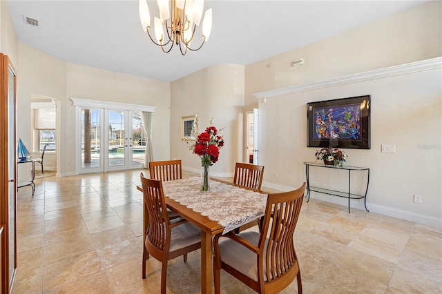 dining room with a notable chandelier and french doors