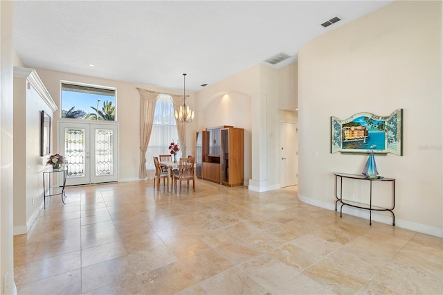 dining space featuring french doors and an inviting chandelier