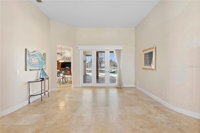 unfurnished room featuring french doors