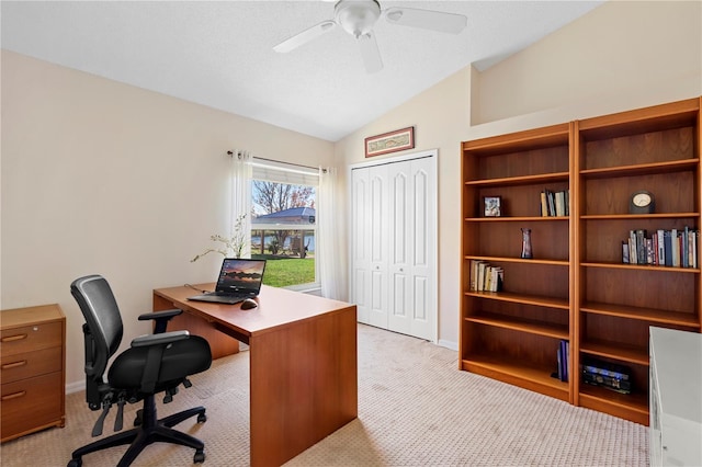 office space with light carpet, a textured ceiling, lofted ceiling, and ceiling fan