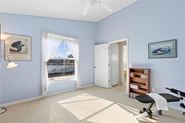 carpeted home office with ceiling fan