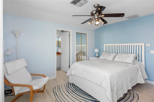 bedroom with light tile patterned flooring, ceiling fan, and a closet