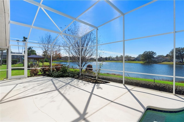 unfurnished sunroom with a water view