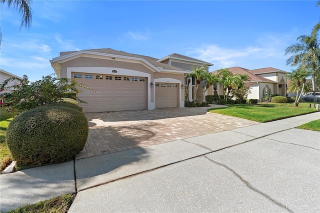 view of front of property with a garage and a front yard