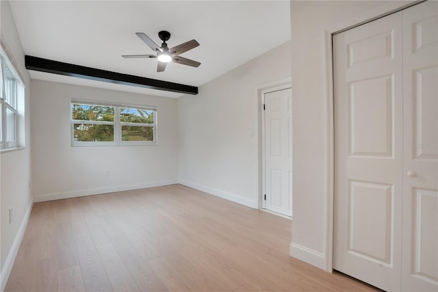 unfurnished bedroom with beamed ceiling, ceiling fan, and light wood-type flooring