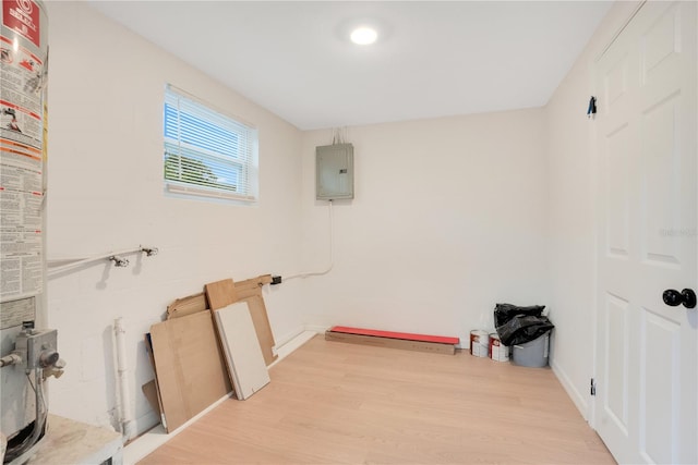 laundry area featuring electric panel and light hardwood / wood-style floors