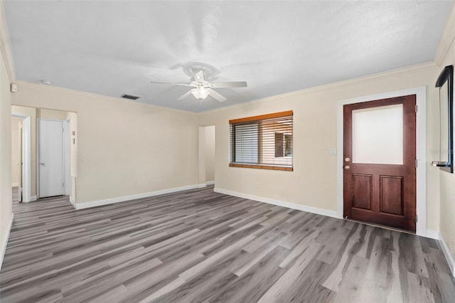 foyer entrance with crown molding, light hardwood / wood-style flooring, and ceiling fan