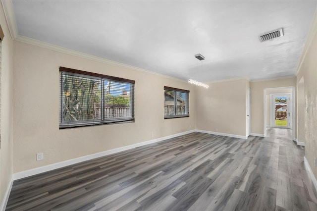 spare room featuring ornamental molding and hardwood / wood-style floors