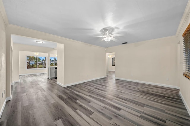 empty room featuring crown molding, dark wood-type flooring, and ceiling fan