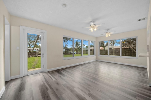 spare room with wood-type flooring and a textured ceiling