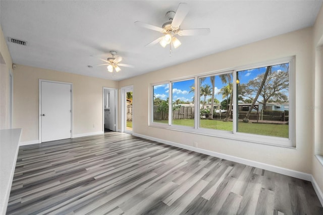 unfurnished room with hardwood / wood-style flooring and ceiling fan