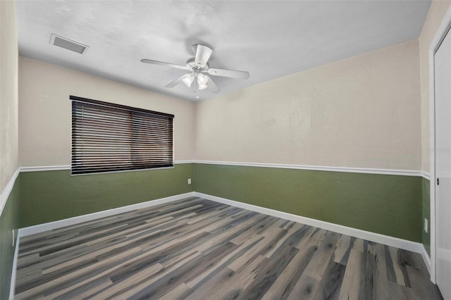 unfurnished room with ceiling fan and wood-type flooring