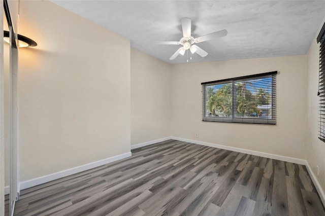 unfurnished room with dark hardwood / wood-style flooring, lofted ceiling, and ceiling fan