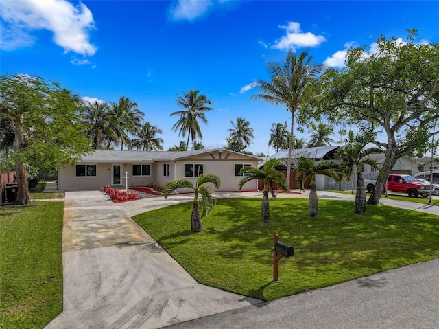 single story home featuring a front lawn