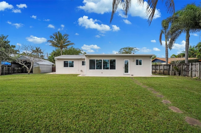 rear view of house with a lawn