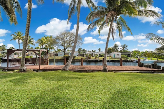 view of dock with a water view and a yard