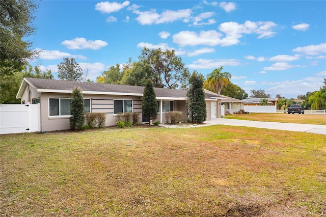 ranch-style house with a garage and a front lawn