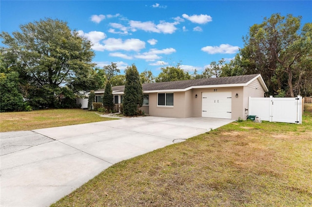 single story home with a garage and a front lawn