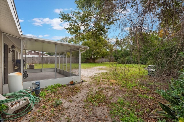 view of yard with cooling unit and a sunroom