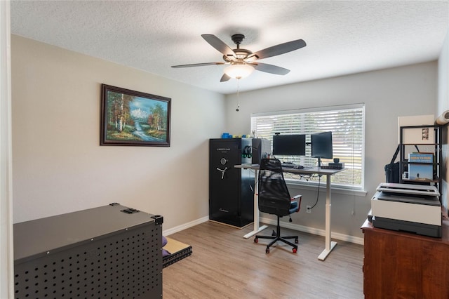 office with ceiling fan, light hardwood / wood-style flooring, and a textured ceiling