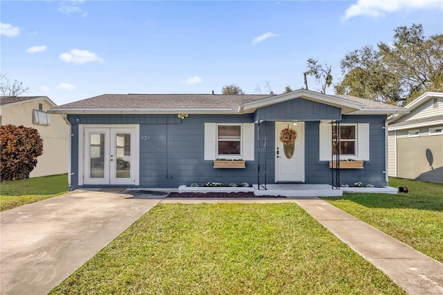 single story home featuring a front lawn and french doors