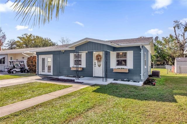 view of front of property with a front yard and cooling unit