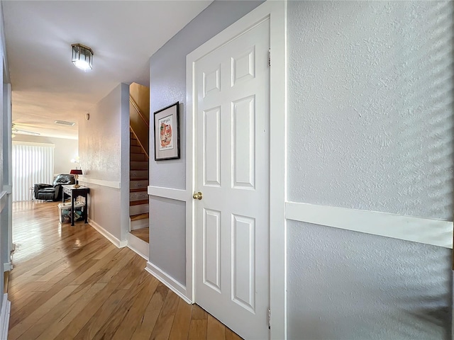 hallway with wood-type flooring