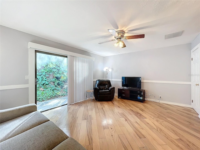 living room featuring ceiling fan and light wood-type flooring