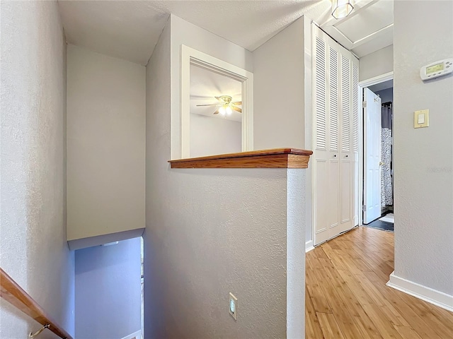 hallway with light hardwood / wood-style floors