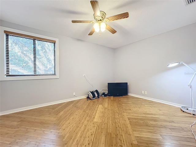 spare room featuring light hardwood / wood-style floors and ceiling fan