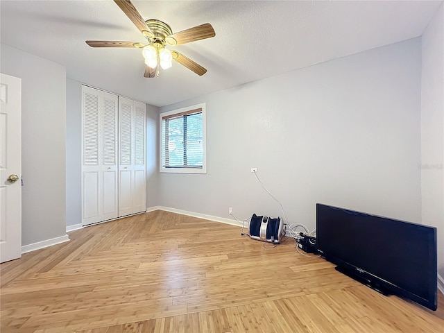 unfurnished bedroom featuring a textured ceiling, ceiling fan, and a closet