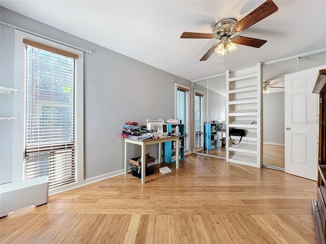 interior space featuring ceiling fan, built in features, and light hardwood / wood-style flooring