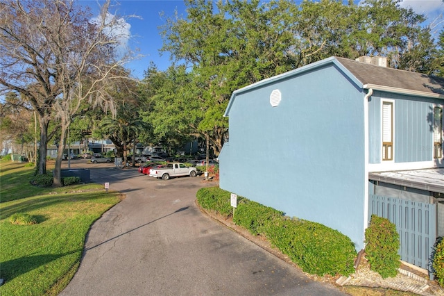 view of side of home featuring a lawn