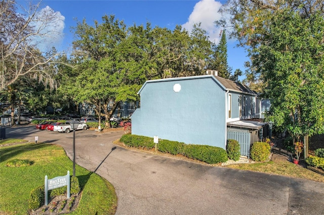 view of side of home with a lawn