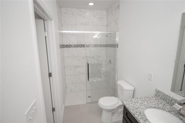 bathroom with an enclosed shower, vanity, and toilet