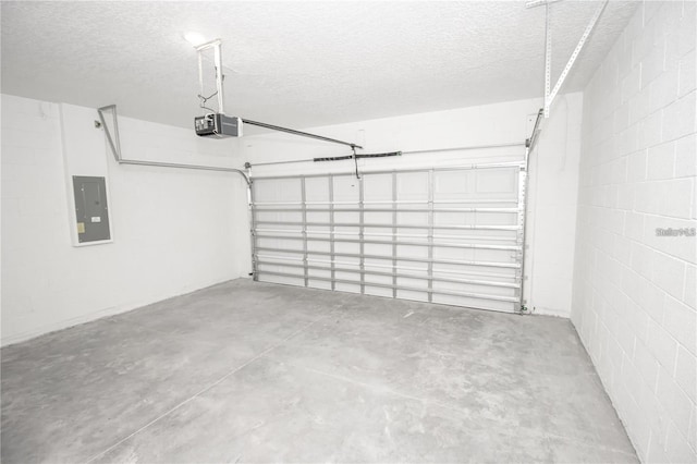 garage with a garage door opener and electric panel