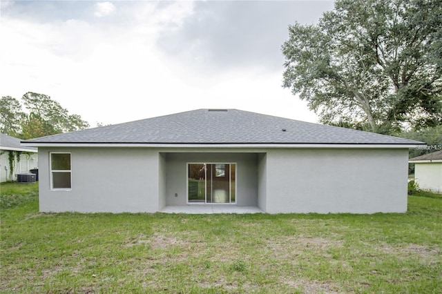 rear view of property featuring central AC unit, a yard, and a patio area