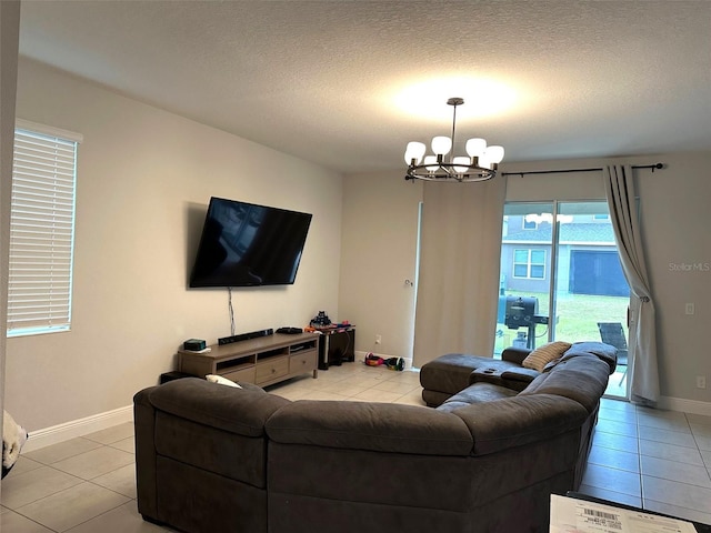 tiled living room featuring a notable chandelier and a textured ceiling