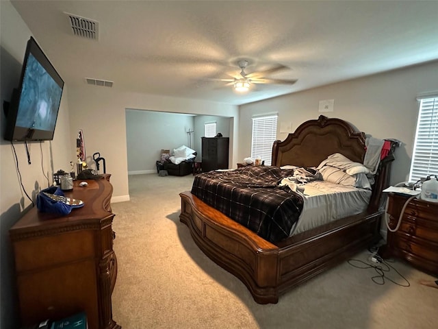 bedroom featuring light carpet and ceiling fan