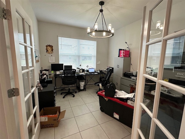 tiled office featuring an inviting chandelier and french doors