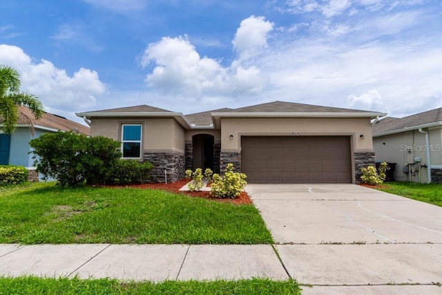 view of front of property featuring a garage and a front lawn