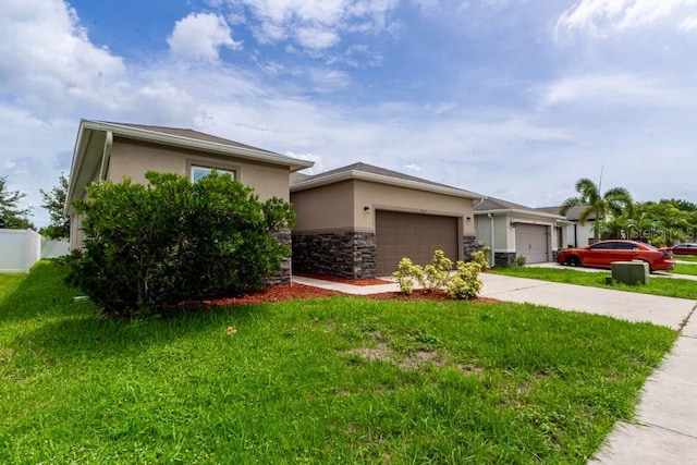 view of front of property featuring a garage and a front yard