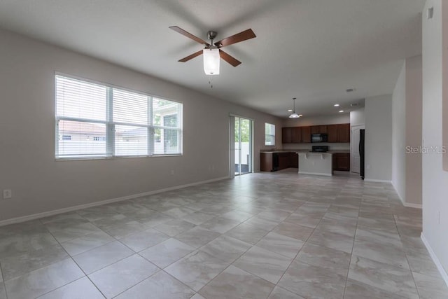 unfurnished living room with ceiling fan