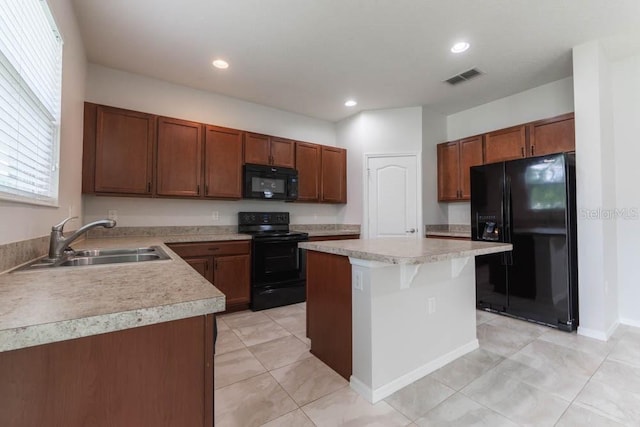 kitchen featuring light tile patterned flooring, a kitchen island, sink, a kitchen breakfast bar, and black appliances