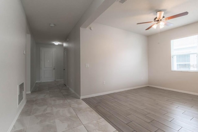 unfurnished room with ceiling fan and light wood-type flooring