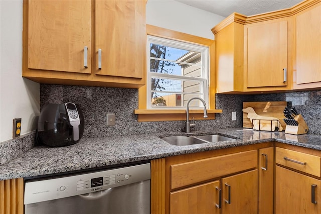 kitchen with tasteful backsplash, dishwasher, sink, and dark stone counters