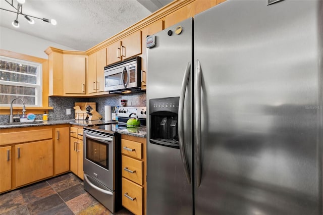 kitchen with light brown cabinetry, sink, decorative backsplash, stainless steel appliances, and a textured ceiling