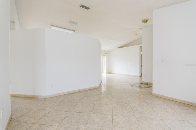 tiled spare room with lofted ceiling