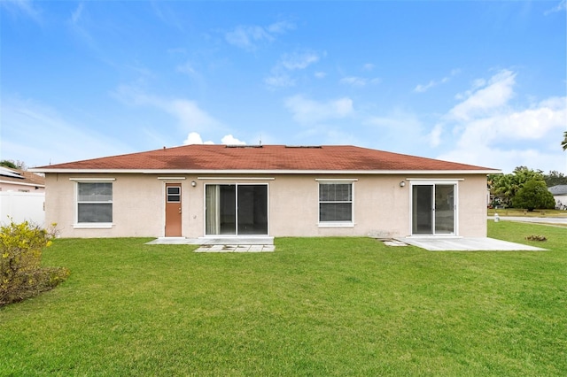 back of house featuring a yard and a patio area