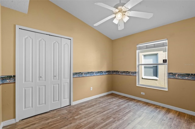 interior space with ceiling fan, lofted ceiling, and light hardwood / wood-style floors